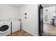 Bright laundry room with washer, dryer, and access to backyard at 7010 Sycamore Grove Ct, Charlotte, NC 28227