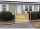 New wood steps and railing leading to front door at 7104 Sandy Smith Rd, Marshville, NC 28103