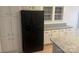 Kitchen with black refrigerator and white cabinets at 7104 Sandy Smith Rd, Marshville, NC 28103