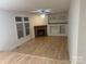 Light-filled living room with fireplace and hardwood floors at 7104 Sandy Smith Rd, Marshville, NC 28103