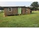 Small wooden outbuilding with green door at 7104 Sandy Smith Rd, Marshville, NC 28103