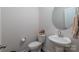 Clean and modern half bathroom with pedestal sink and round mirror at 7163 Yardley St, Gastonia, NC 28056