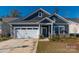 Gray exterior with white garage door and landscaping at 7163 Yardley St, Gastonia, NC 28056