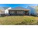 Rear view of the house, showcasing the screened porch and yard at 7163 Yardley St, Gastonia, NC 28056