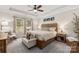 Relaxing main bedroom with a wooden bed frame, ceiling fan, and plenty of natural light at 7163 Yardley St, Gastonia, NC 28056