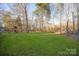 Large grassy backyard with playset and wooded area at 819 Lillieshall Rd, Waxhaw, NC 28173