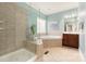 Spa-like bathroom with a walk-in shower and corner bathtub at 819 Lillieshall Rd, Waxhaw, NC 28173