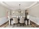 Elegant dining room with a large table, chandelier, and hardwood floors at 819 Lillieshall Rd, Waxhaw, NC 28173