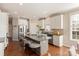 Modern kitchen with granite island, white cabinets, and stainless steel appliances at 819 Lillieshall Rd, Waxhaw, NC 28173