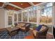 Spacious screened porch with wooded views and wicker furniture at 819 Lillieshall Rd, Waxhaw, NC 28173