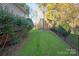 Landscaped side yard with lush greenery and privacy fence at 819 Lillieshall Rd, Waxhaw, NC 28173