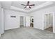 Primary bedroom with ceiling fan, carpet, and access to bathroom and closet at 8243 Bretton Woods Dr, Charlotte, NC 28227