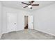 Spacious bedroom with ceiling fan and access to bathroom at 8243 Bretton Woods Dr, Charlotte, NC 28227