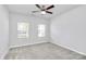 Well-lit bedroom featuring gray carpeting and two windows at 8243 Bretton Woods Dr, Charlotte, NC 28227