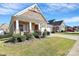 Craftsman style home with a welcoming front porch and landscaping at 8243 Bretton Woods Dr, Charlotte, NC 28227