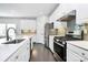 Modern kitchen with white cabinets, stainless steel appliances, and quartz countertops at 8243 Bretton Woods Dr, Charlotte, NC 28227