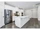 Spacious kitchen boasts white cabinetry, stainless steel appliances, and an island at 8243 Bretton Woods Dr, Charlotte, NC 28227