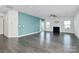 Living room features hardwood floors, fireplace, and a calming blue accent wall at 8243 Bretton Woods Dr, Charlotte, NC 28227