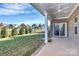 Covered patio with ceiling fan, overlooking backyard at 8243 Bretton Woods Dr, Charlotte, NC 28227