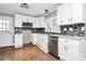 Modern white kitchen with granite countertops and stainless steel appliances at 835 Belmont Ave, Charlotte, NC 28205