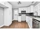 Modern white kitchen with granite countertops and stainless steel appliances at 835 Belmont Ave, Charlotte, NC 28205