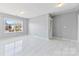 Bright bedroom with large window and marble-look flooring at 8506 Delamere Ln, Charlotte, NC 28269