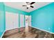 Spacious bedroom with teal walls, wood flooring, and double doors at 8506 Delamere Ln, Charlotte, NC 28269