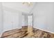 Well-lit bedroom featuring hardwood floors and double doors at 8506 Delamere Ln, Charlotte, NC 28269