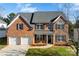 Brick house with two-car garage and landscaped yard at 8506 Delamere Ln, Charlotte, NC 28269