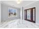 Living room with marble floors and entry door at 8506 Delamere Ln, Charlotte, NC 28269