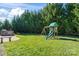 Backyard with playset and privacy hedge at 9124 Longvale Ln, Charlotte, NC 28214