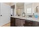 Double vanity bathroom with granite countertops and dark wood cabinets at 9124 Longvale Ln, Charlotte, NC 28214