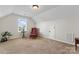 Bonus room with window, armchair, and ottoman at 9124 Longvale Ln, Charlotte, NC 28214