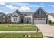 Beautiful two-story home with stone accents and a landscaped lawn at 9124 Longvale Ln, Charlotte, NC 28214