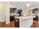 Modern kitchen with dark cabinetry and granite island at 9124 Longvale Ln, Charlotte, NC 28214