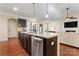 Modern kitchen with large island and stainless steel appliances at 9124 Longvale Ln, Charlotte, NC 28214