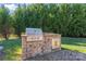 Outdoor kitchen with built-in grill and storage at 9124 Longvale Ln, Charlotte, NC 28214