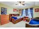 Well-lit bedroom with twin beds, dresser, and built-in shelves at 1009 Chapman St, Indian Trail, NC 28079