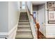 Gray carpeted staircase with wooden handrail at 1009 Chapman St, Indian Trail, NC 28079