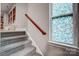 Gray carpeted staircase with wooden handrail and stained glass window at 1009 Chapman St, Indian Trail, NC 28079