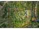 Aerial view of property with a circular house on a wooded lot surrounded by a red border at 10200 Amsterdam Dr, Mount Pleasant, NC 28124
