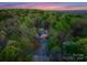 Secluded home surrounded by trees and nature with an inviting driveway and gorgeous sunset views at 10200 Amsterdam Dr, Mount Pleasant, NC 28124