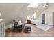 Bright bedroom with comfortable chair, featuring a skylight and ample natural light at 10200 Amsterdam Dr, Mount Pleasant, NC 28124