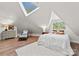 Bright bedroom with a skylight, sloped ceilings, and a cozy sitting area, offering a relaxing space at 10200 Amsterdam Dr, Mount Pleasant, NC 28124