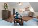 Well-lit bedroom boasts hardwood floors, comfortable seating, and decor that complements the space at 10200 Amsterdam Dr, Mount Pleasant, NC 28124