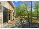 Relaxing outdoor deck with a table and chairs and wooded scenery at 10200 Amsterdam Dr, Mount Pleasant, NC 28124