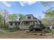 Charming home showcasing its unique architectural design and curb appeal with landscaped front yard at 10200 Amsterdam Dr, Mount Pleasant, NC 28124