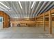 Spacious garage interior featuring a loft with work benches and storage shelves at 10200 Amsterdam Dr, Mount Pleasant, NC 28124