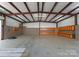 Garage interior featuring cabinets, a concrete floor, exposed beam ceiling, and lighting at 10200 Amsterdam Dr, Mount Pleasant, NC 28124