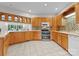 Open kitchen showcasing ample wood cabinets, modern appliances, and a breakfast bar at 10200 Amsterdam Dr, Mount Pleasant, NC 28124